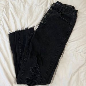 Raw hem, distressed button fly jeans.